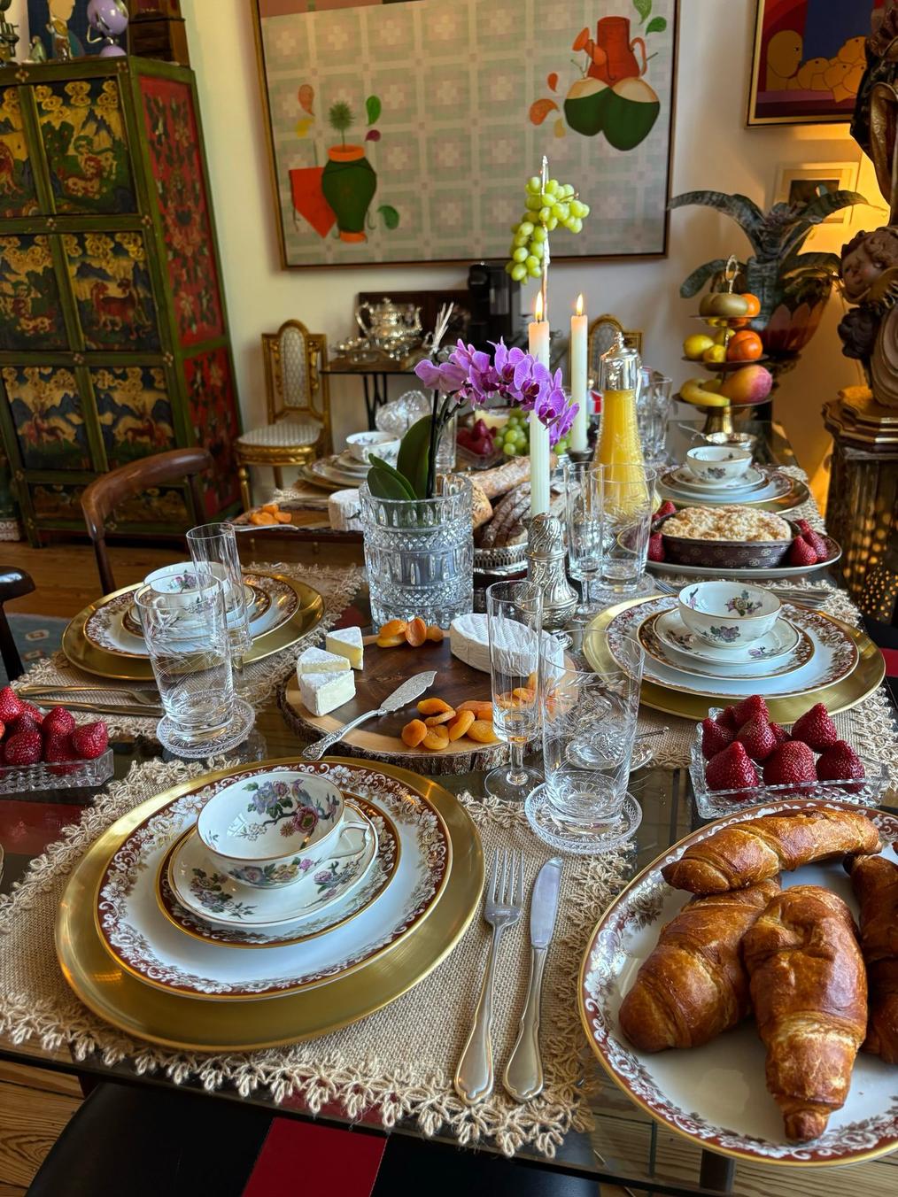 A private brunch table set with antique porcelain, fruit and pastries
